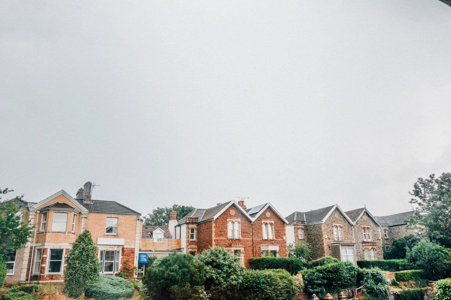 Row of colorful houses seen through a window on a bright day.